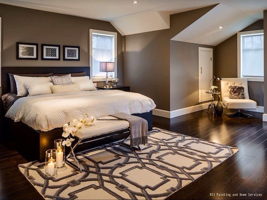 A Warm And Cozy Bedroom With Dark Hardwood Floors Brown