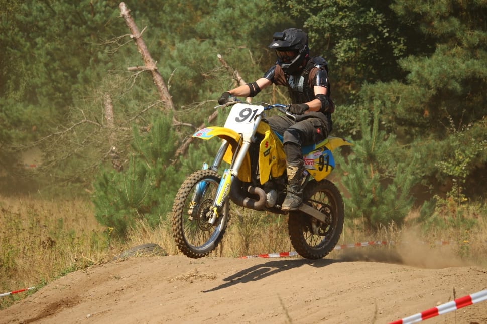 Man Riding Yellow And White Dirt Bike Performing Motor , HD Wallpaper & Backgrounds