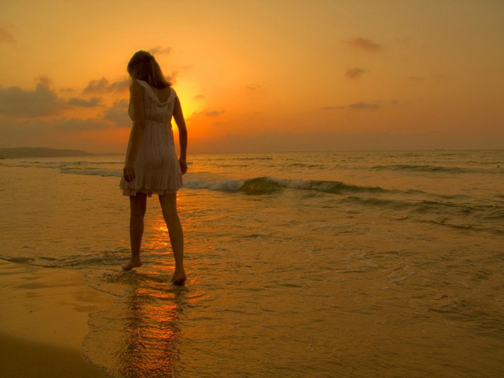 alone girl walking on beach